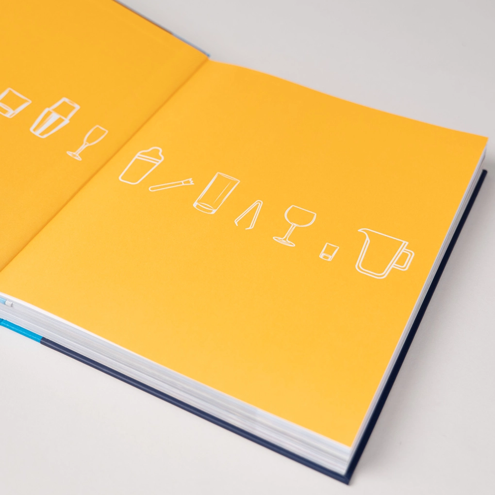 The yellow endpapers featuring stylish cocktail iconography.